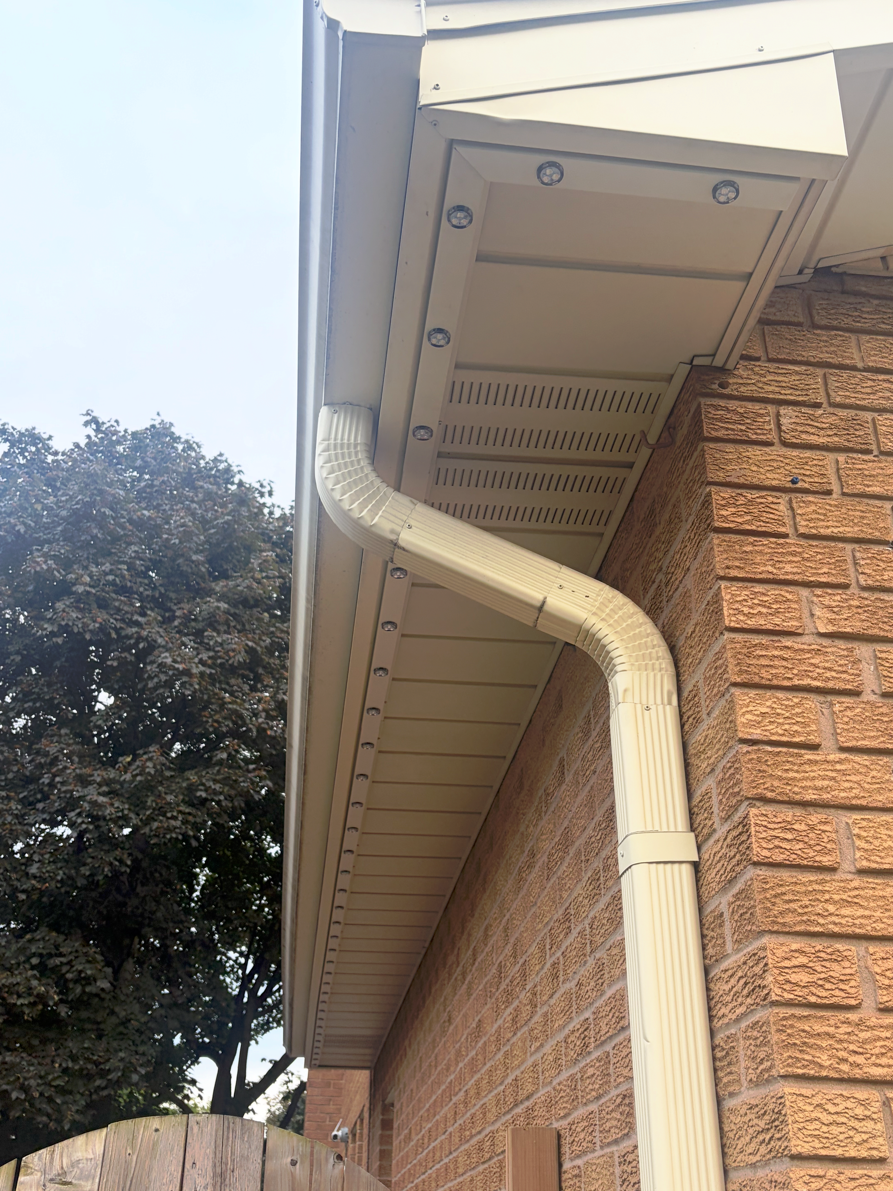 Colour-matched aluminum LED track installed flush along a home's soffit